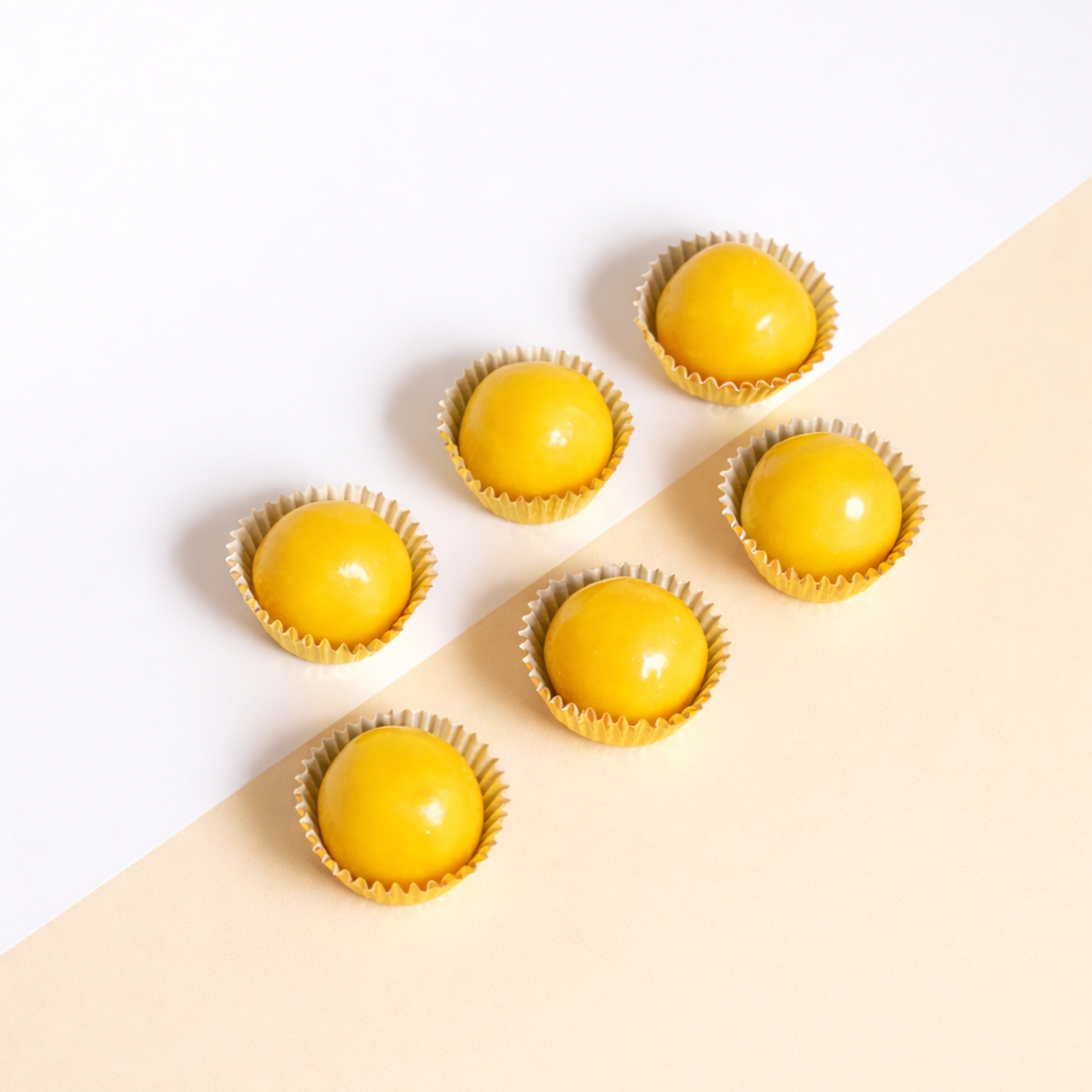Pineapple tarts in wrappers on a beige background