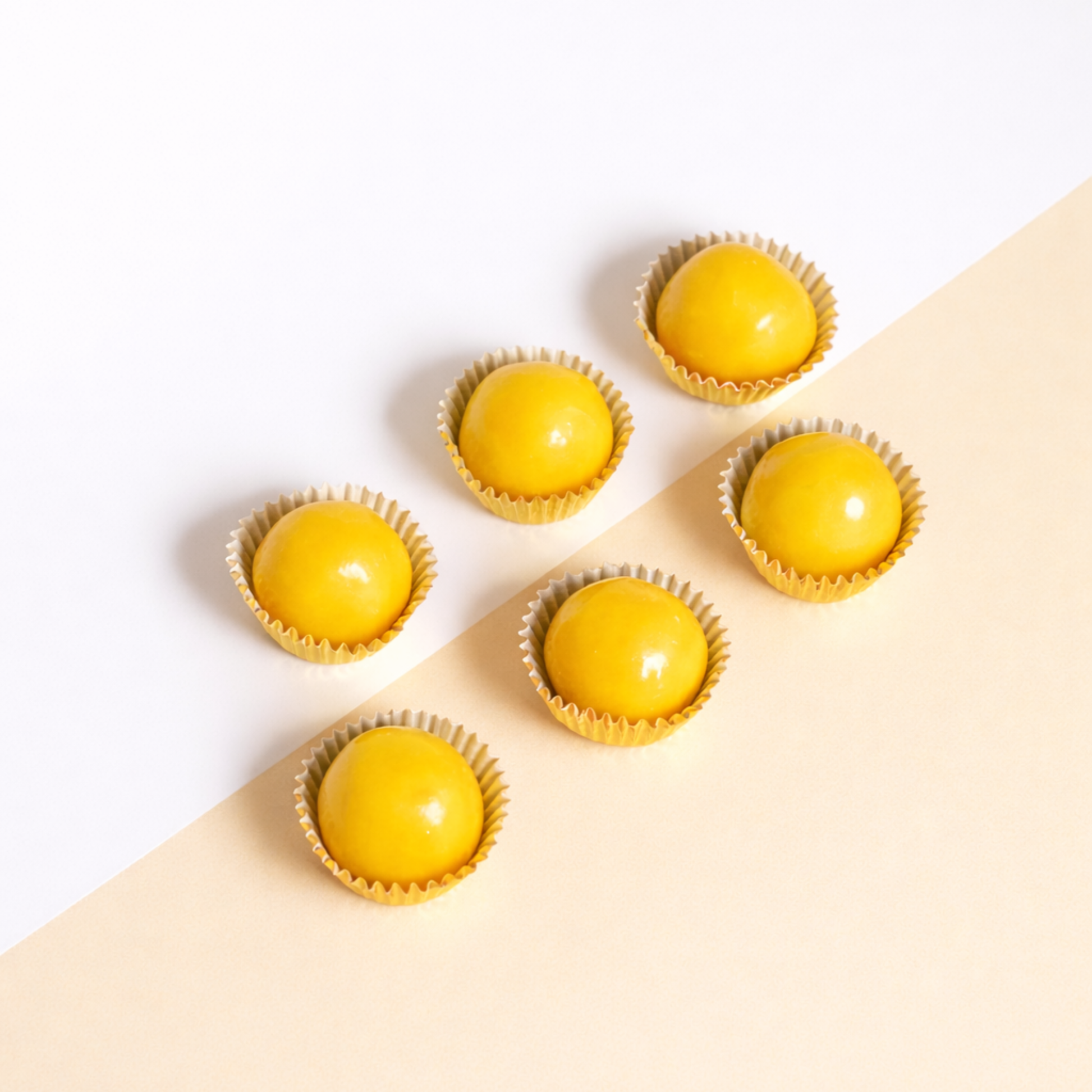 Pineapple tarts in wrappers on a beige background