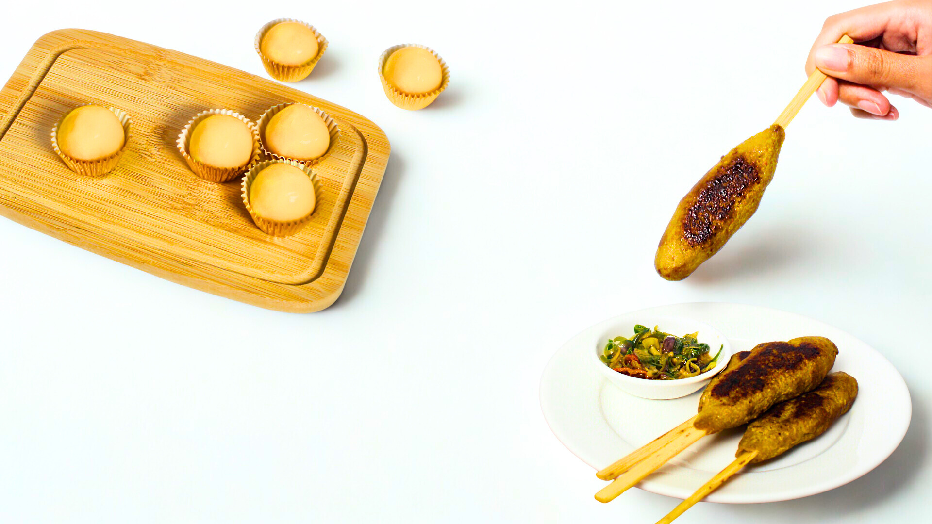 Wooden skewers with food on a white background